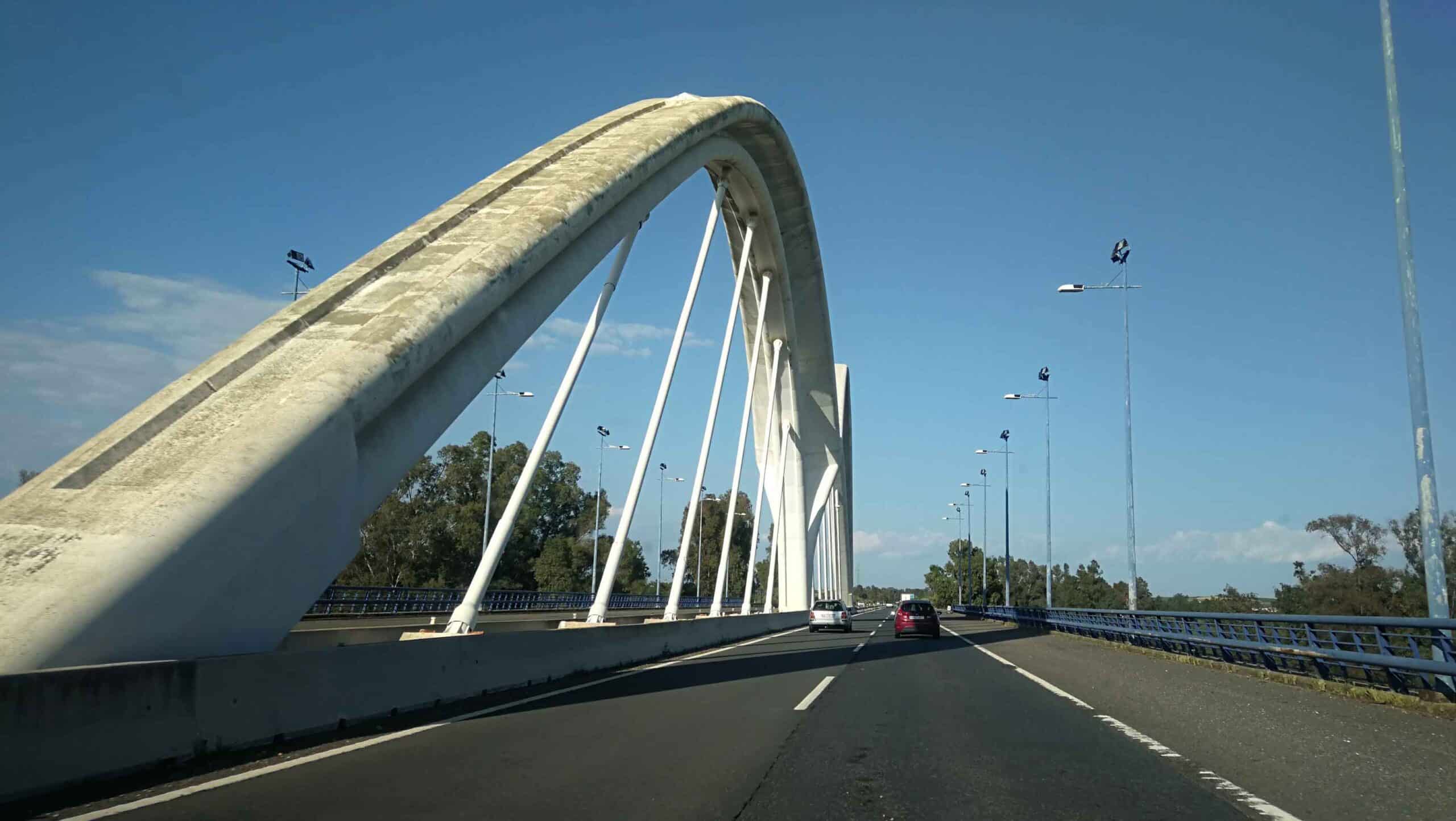 El puente sobre el río Odiel se ubica en la A-49 Autovía del Quinto Centenario, tramo San Juan del Puerto-Enlace Aljaraque.

Está formado por dos arcos atirantados de hormigón armado de 76 metros de luz. El tablero inferior, de 29 metros de anchura, está supendido mediante 12 tirantes dispuestos en el eje del mismo.