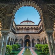 El Real Alcázar de Sevilla es un conjunto palaciego amurallado construido en diferentes etapas históricas. El palacio original se edificó en la Alta Edad Media. Se conservan algunos vestigios de arte islámico y, de la etapa posterior a la conquista castellana, un espacio palaciego mudéjar y otro de estilo gótico. En reformas posteriores se añadieron elementos renacentistas, manieristas​ y barrocos​.
Es la residencia de los miembros de la familia real española cuando visitan Sevilla.​ Esto hace que sea el palacio real en uso más antiguo de Europa. Es Patrimonio de la humanidad por la UNESCO.